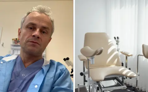 Manlig gynekolog i blå skyddsrock framför gynekologstol.